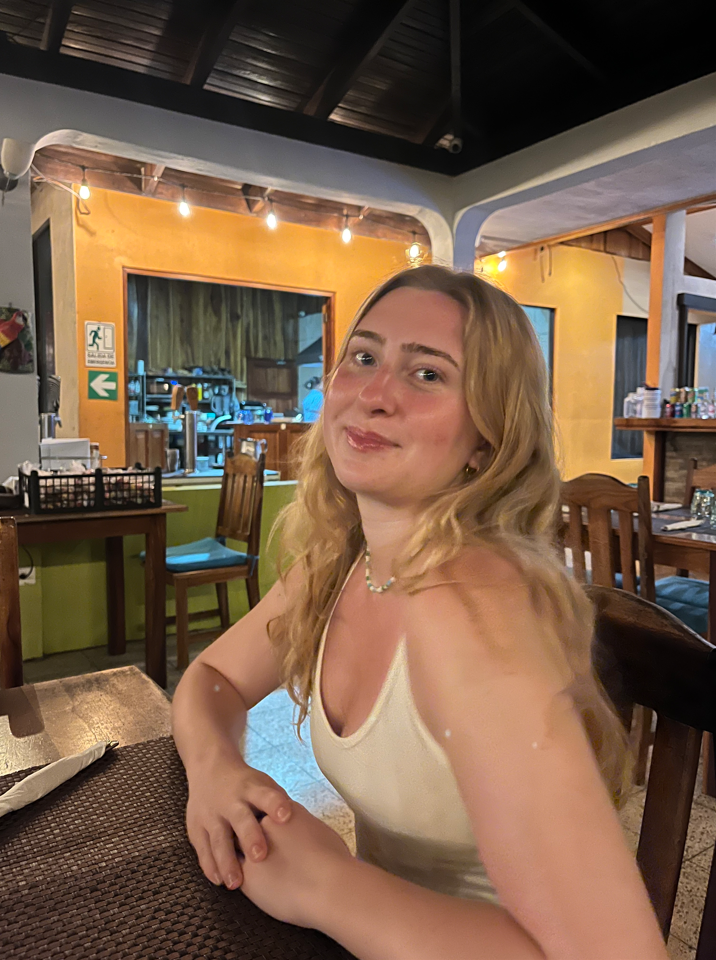 Photo of Julia Rhymes at a table smiling